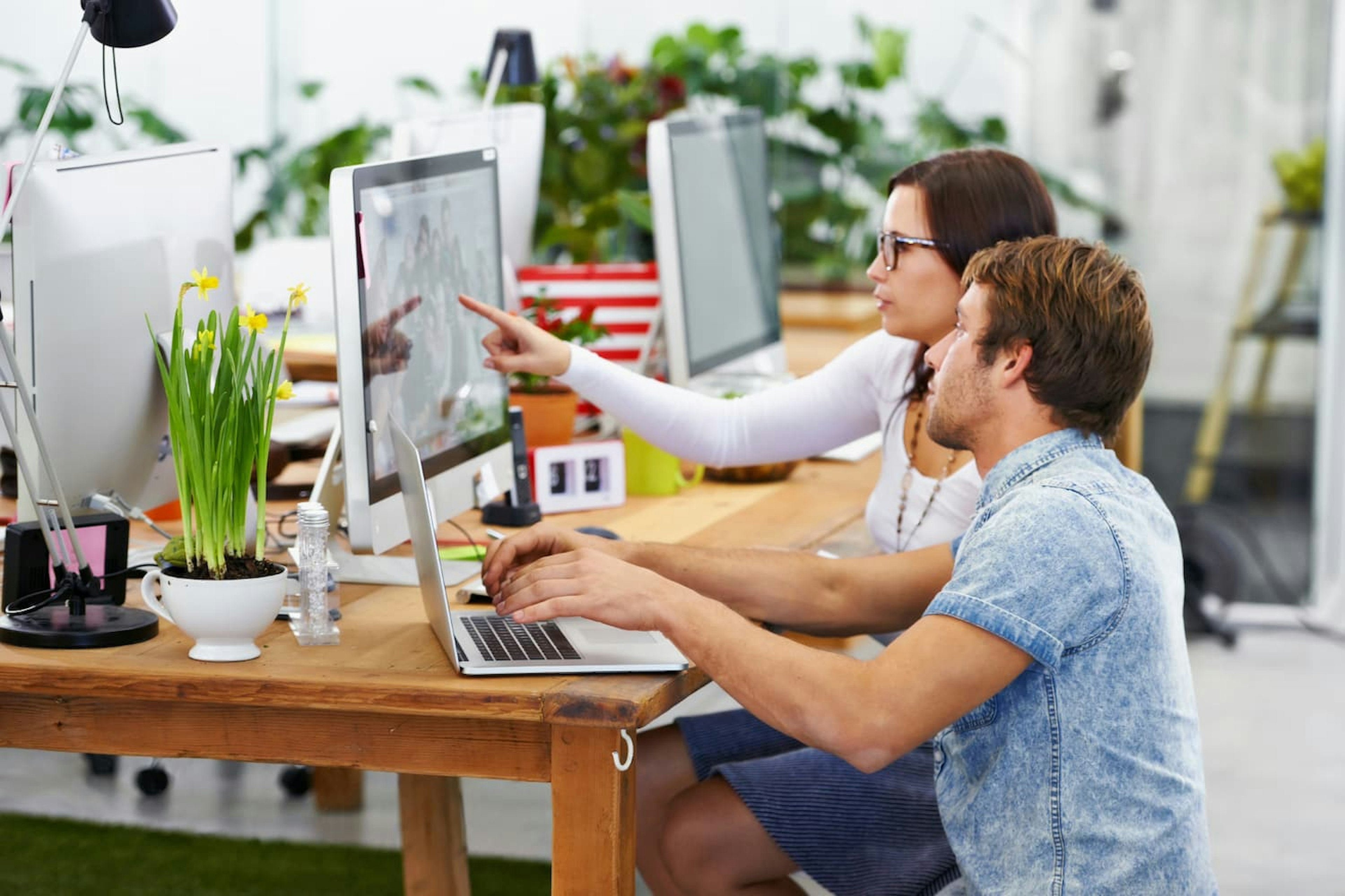 Man and woman working together at computer